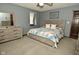Bedroom with neutral color palette, wood dresser, and colorful quilt on the bed at 6276 Quail Rdg W Dr, Plainfield, IN 46168