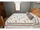 Bedroom featuring gray walls and wood bed frame and a beautiful quilt at 6276 Quail Rdg W Dr, Plainfield, IN 46168