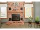 Detailed view of brick fireplace featuring a decorative mantel, flanked by windows for natural lighting and warmth at 6276 Quail Rdg W Dr, Plainfield, IN 46168