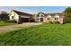 Attractive home featuring a brick facade, well-maintained lawn, and a spacious driveway with curb appeal at 6276 Quail Rdg W Dr, Plainfield, IN 46168