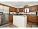 Kitchen features stainless steel appliances, wooden cabinets, and an island with seating at 6276 Quail Rdg W Dr, Plainfield, IN 46168