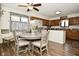 Well-lit kitchen and dining area featuring stainless steel appliances and wooden cabinets at 6276 Quail Rdg W Dr, Plainfield, IN 46168
