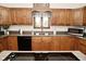 Kitchen with oak cabinets, stainless steel sink and a window with lots of natural light at 6276 Quail Rdg W Dr, Plainfield, IN 46168