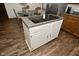 Kitchen island with white cabinets and cooktop at 6276 Quail Rdg W Dr, Plainfield, IN 46168