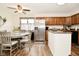Well-lit kitchen and dining area with stainless steel appliances and wooden cabinets at 6276 Quail Rdg W Dr, Plainfield, IN 46168