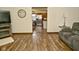 Open-concept living room showcasing seamless flow, wood flooring, and a view into the kitchen at 6276 Quail Rdg W Dr, Plainfield, IN 46168