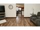 Open-concept living room showcasing seamless flow, wood flooring, and a view into the kitchen at 6276 Quail Rdg W Dr, Plainfield, IN 46168