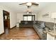 Comfortable living room features a large sectional sofa, wood flooring, and natural light at 6276 Quail Rdg W Dr, Plainfield, IN 46168