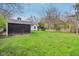 Expansive backyard featuring lush green grass, a shed, and plenty of space for recreation at 6481 Michigan Rd, Indianapolis, IN 46268