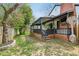 Back porch with outdoor seating area, complemented by a spacious yard with mature trees at 6481 Michigan Rd, Indianapolis, IN 46268