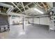 Spacious unfinished basement with gray painted floor and exposed ceiling at 6481 Michigan Rd, Indianapolis, IN 46268
