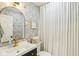 Stylish bathroom featuring patterned wallpaper, a modern vanity with a gold faucet, and a round mirror at 6481 Michigan Rd, Indianapolis, IN 46268