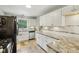 Bright kitchen features white cabinets, stainless steel appliances, and unique tile floors at 6481 Michigan Rd, Indianapolis, IN 46268