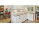 Bright kitchen with white cabinetry and updated countertops with bar seating at 6481 Michigan Rd, Indianapolis, IN 46268