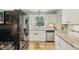 Bright kitchen with white cabinets and stainless steel appliances at 6481 Michigan Rd, Indianapolis, IN 46268