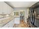 The kitchen has modern white cabinets and countertops with a view into the dining room at 6481 Michigan Rd, Indianapolis, IN 46268