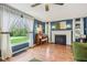 Elegant living room featuring large windows, hardwood floors, a decorative fireplace, and cozy ambiance at 6481 Michigan Rd, Indianapolis, IN 46268