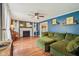 Spacious living room with a fireplace, a ceiling fan, and comfortable olive green sofa at 6481 Michigan Rd, Indianapolis, IN 46268