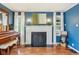 Cozy living room with a classic fireplace, hardwood floors, and natural light flooding through the windows at 6481 Michigan Rd, Indianapolis, IN 46268