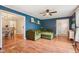 Comfortable living room features hardwood floors, stylish blue walls, and an inviting green sofa at 6481 Michigan Rd, Indianapolis, IN 46268