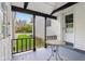 Inviting covered porch with dark beams, a charming table, and a view of the front yard at 6481 Michigan Rd, Indianapolis, IN 46268