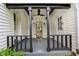 Charming covered porch with dark beams, a ceiling fan, and a view of the entrance at 6481 Michigan Rd, Indianapolis, IN 46268