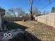 A spacious, fenced backyard with mature trees and some foliage at 6642 E 47Th St, Indianapolis, IN 46226