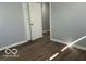 A spacious bedroom with sleek, dark wood-look floors and neutral gray walls at 6642 E 47Th St, Indianapolis, IN 46226