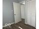 Bedroom with closet, neutral paint, and wood-look flooring at 6642 E 47Th St, Indianapolis, IN 46226
