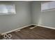 A serene bedroom showcasing natural light, wood-look floors and two windows at 6642 E 47Th St, Indianapolis, IN 46226
