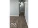 A clean hallway with hardwood floors, connecting different areas of the home with ease and style at 6642 E 47Th St, Indianapolis, IN 46226
