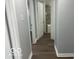 Hallway featuring updated wood-look floors and neutral gray walls at 6642 E 47Th St, Indianapolis, IN 46226