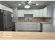 A modern kitchen with white cabinets and stainless steel appliances offers style and functionality for the home chef at 6642 E 47Th St, Indianapolis, IN 46226