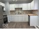 A modern kitchen featuring white cabinets, stainless steel appliances, and stylish backsplash, perfect for cooking at 6642 E 47Th St, Indianapolis, IN 46226