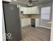 A modern kitchen featuring white cabinets, stainless steel appliances, and stylish backsplash, perfect for cooking at 6642 E 47Th St, Indianapolis, IN 46226