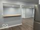 Open living area with breakfast bar, neutral paint, and wood-look flooring at 6642 E 47Th St, Indianapolis, IN 46226