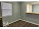 Living room area with two windows and wood-look flooring at 6642 E 47Th St, Indianapolis, IN 46226