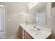 Well-lit bathroom with single vanity, spacious mirror, and neutral color palette at 6681 Keepsake Dr, Whitestown, IN 46075