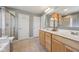Bathroom boasts double sinks, separate tub, and glass-enclosed shower, all with neutral tones at 6681 Keepsake Dr, Whitestown, IN 46075