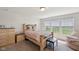 Bright bedroom featuring a wooden bed, three large windows, and neutral wall color at 6681 Keepsake Dr, Whitestown, IN 46075