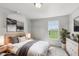 Calm bedroom with large window views of the outdoors and bedside tables with soft lighting at 6681 Keepsake Dr, Whitestown, IN 46075