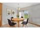 Bright dining area with modern lighting fixtures and sliding doors to the backyard at 6681 Keepsake Dr, Whitestown, IN 46075