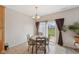 Dining area with slider to the backyard, a wooden table set, and tile floors at 6681 Keepsake Dr, Whitestown, IN 46075