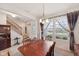 Bright dining room features a wooden table set, stairway access, and a window with backyard views at 6681 Keepsake Dr, Whitestown, IN 46075