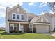 Charming two-story home with brick and siding and well-manicured front lawn at 6681 Keepsake Dr, Whitestown, IN 46075