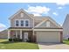 Charming two-story home with brick and vinyl siding, complemented by a well-manicured lawn at 6681 Keepsake Dr, Whitestown, IN 46075