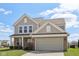 Charming two-story home with brick and vinyl siding, complemented by a well-manicured lawn at 6681 Keepsake Dr, Whitestown, IN 46075