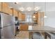 Bright kitchen featuring stainless steel appliances, light wood cabinets, and a convenient center island at 6681 Keepsake Dr, Whitestown, IN 46075