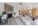 Open living room with fireplace, seamlessly connected to the kitchen with a breakfast bar at 6681 Keepsake Dr, Whitestown, IN 46075