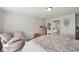 Bright main bedroom with neutral walls, a soft chair, and view of attached bathroom at 6681 Keepsake Dr, Whitestown, IN 46075